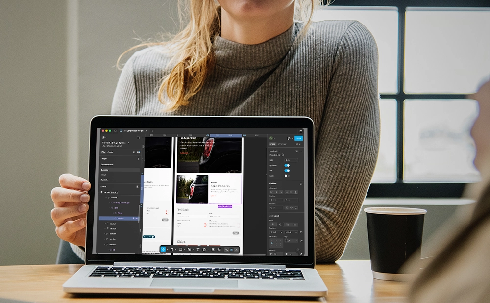 A woman presenting The Delta Design System Figma file on a laptop